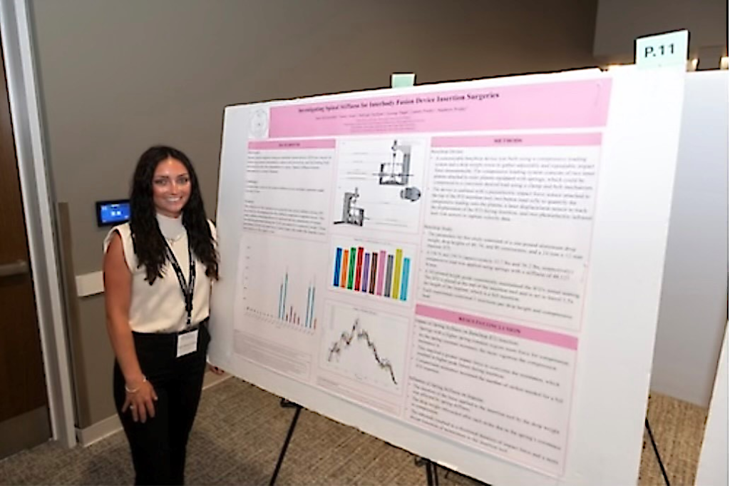 Kate Blankenship standing next to research poster.