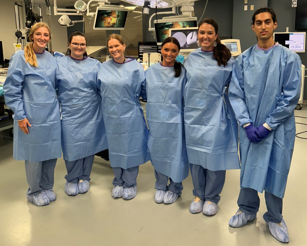 Kate Blankenship and five others wearing surgical gowns.