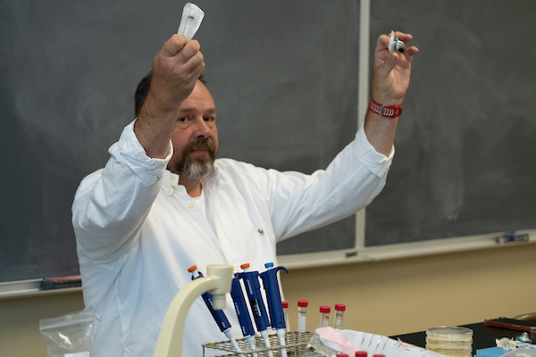 Instructor demonstrating some molecular biology tools.